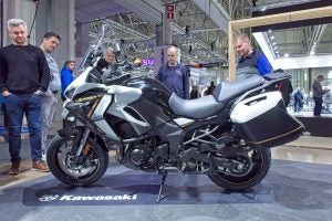 They're probably trying to figure out what country this Kawi was made in. 
Photo: Raimo Bergroth / Shutterstock.com